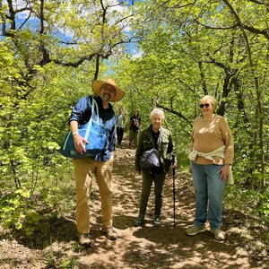 Chris Newton with two people on a forest path