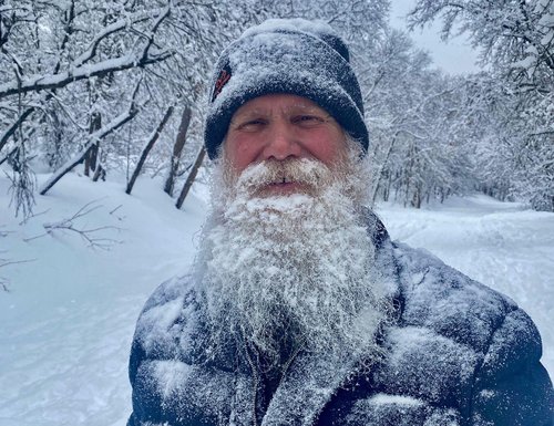 James Batton standing in front of snow-covered tress