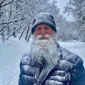 James Batton standing in front of snow-covered tress