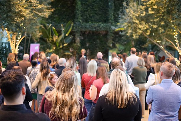 Guests attending a corporate event in the Red Butte Garden Orangerie.