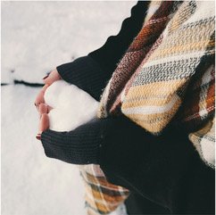 Woman holding a heart-shaped snowball