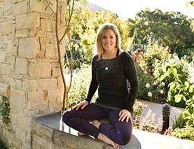Kristin Vance sitting on a wall in the Garden